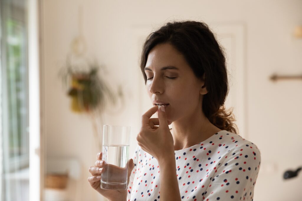 Woman taking a pill