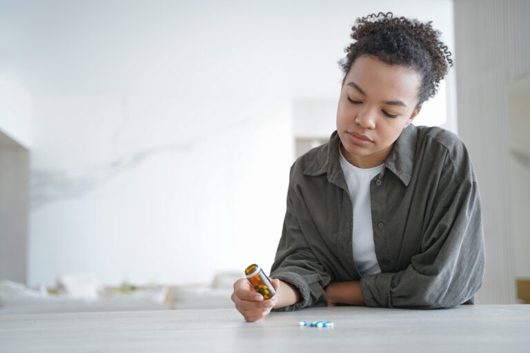 Woman Looking At Pills