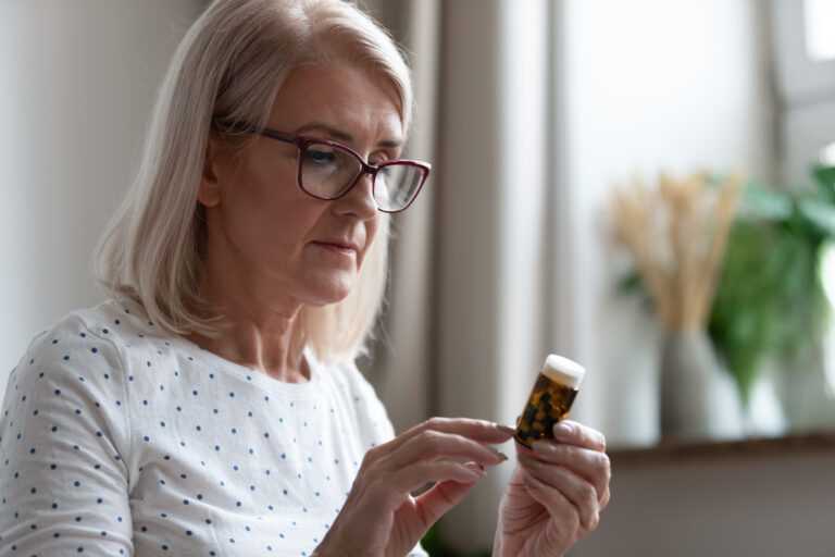 Woman Reading Pill Bottle