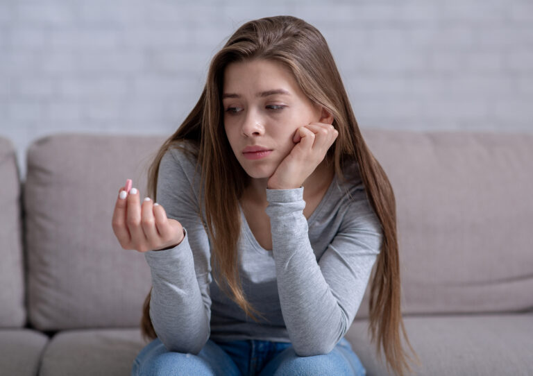 Woman Looking At Pill