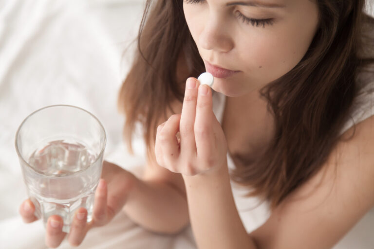 Women taking a pill