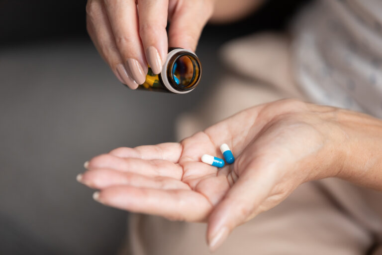 Woman With Pills In Hand