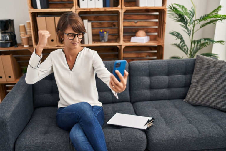 Woman punching at phone while on therapy session. She sees signs of a bad therapist.