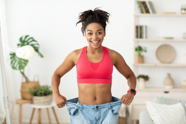 Woman wearing pants that are to big to signify Ozempic vs Wegovy