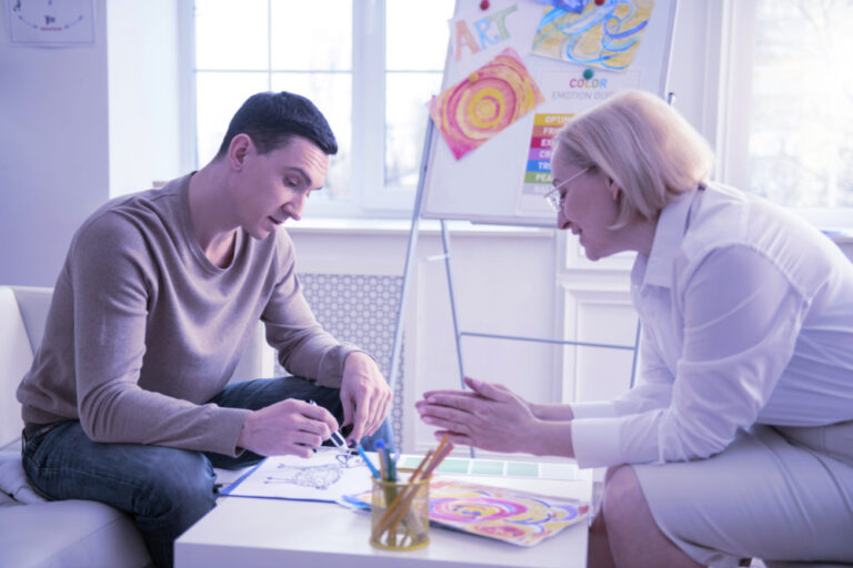 Female therapist with male client using art therapy as an alternative mental health therapy