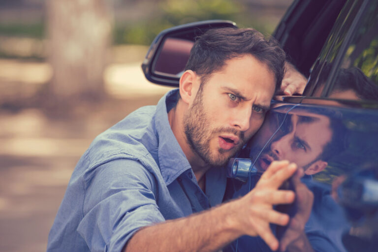 Man in his early 40's stressing about a scratch on his car to symbolize OCD vs anxiety?